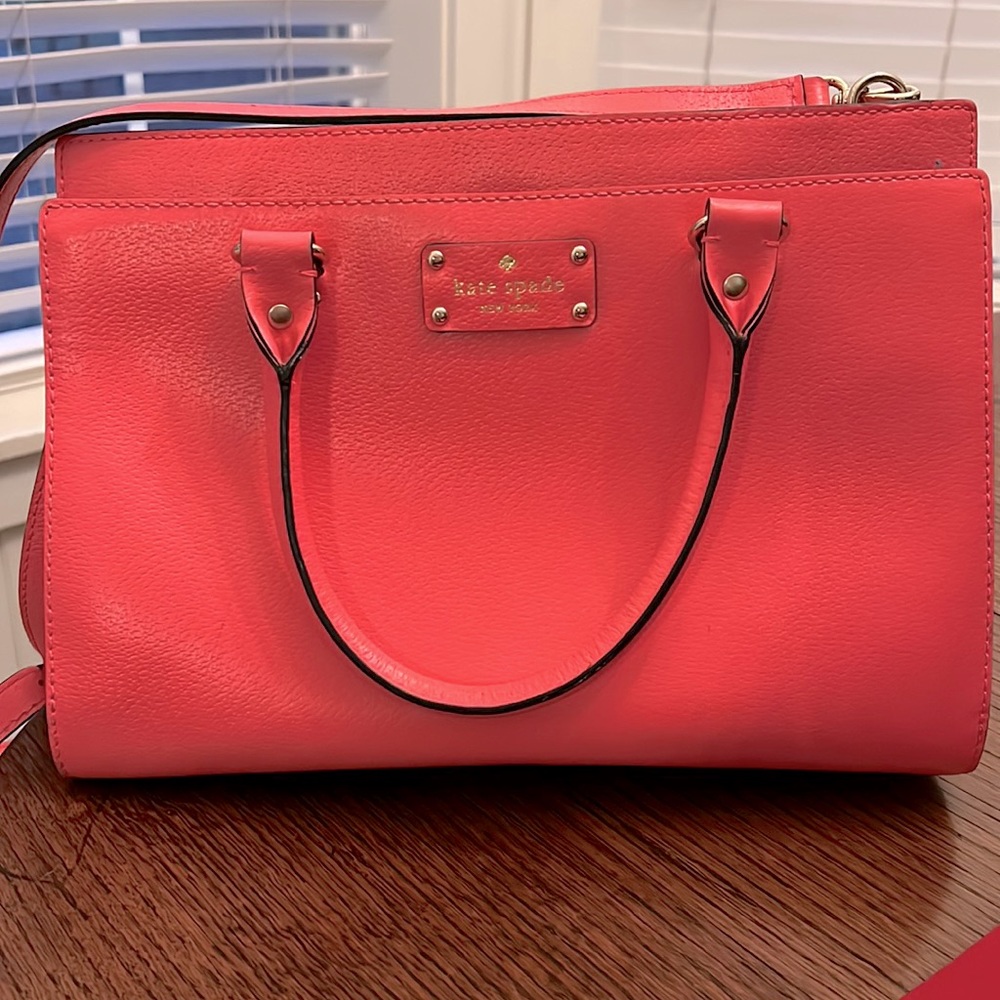 Kate Spade Purse in coral. Shoulder strap and handles for easy carrying.